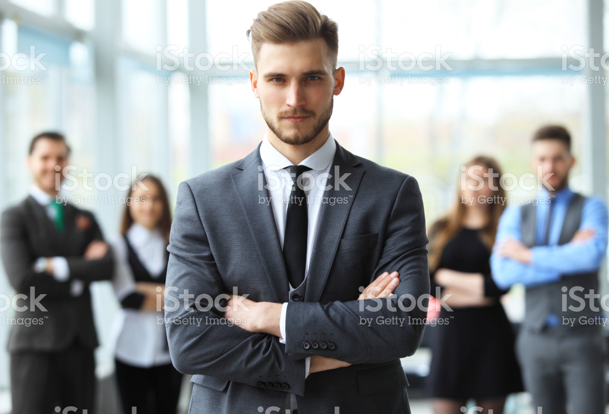 Happy smart business man with team mates discussing in the background